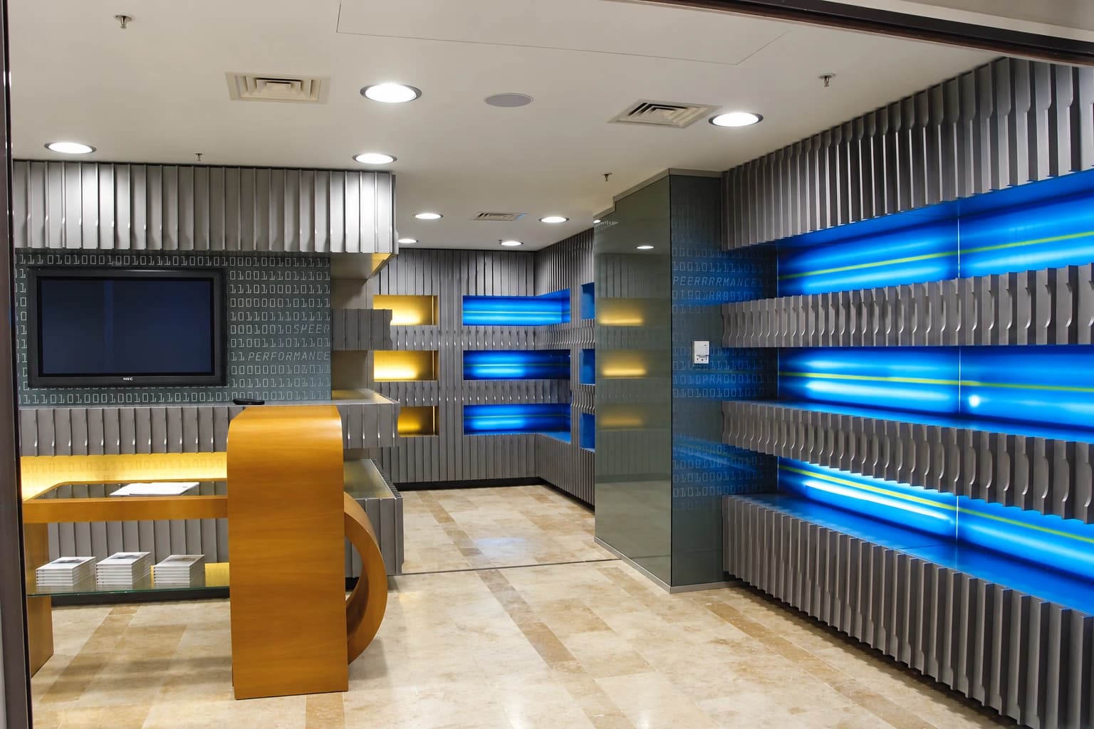 D-Point Showroom — Mayadrom: Yellow desk area and illuminated wall arrangement
