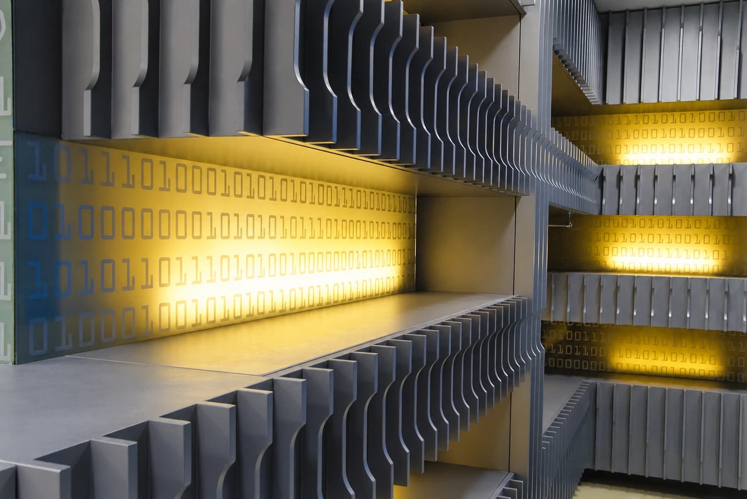 D-Point Showroom — Mayadrom: Close view of the yellow illuminated wall and shelving